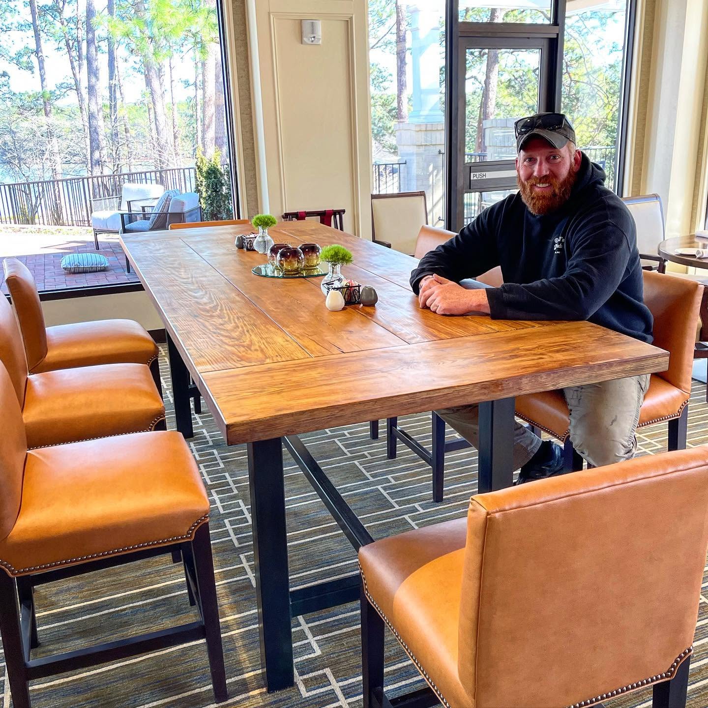 Jake sitting on a finished custom table.