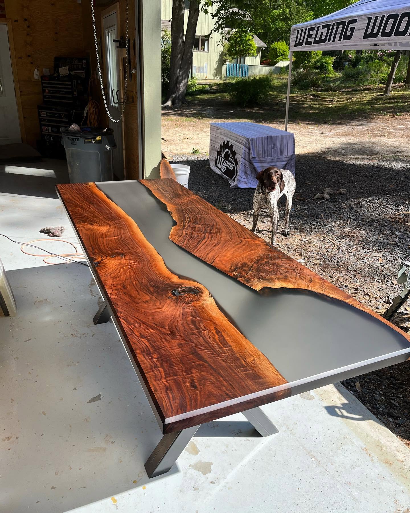 Live edge black walnut conference table with a blue epoxy river.