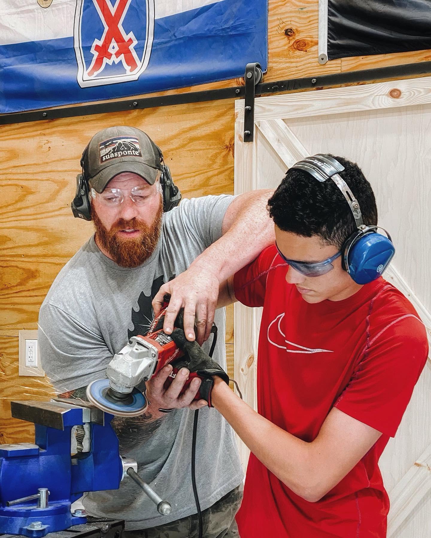 Father and son learning the trades together in the workshop.